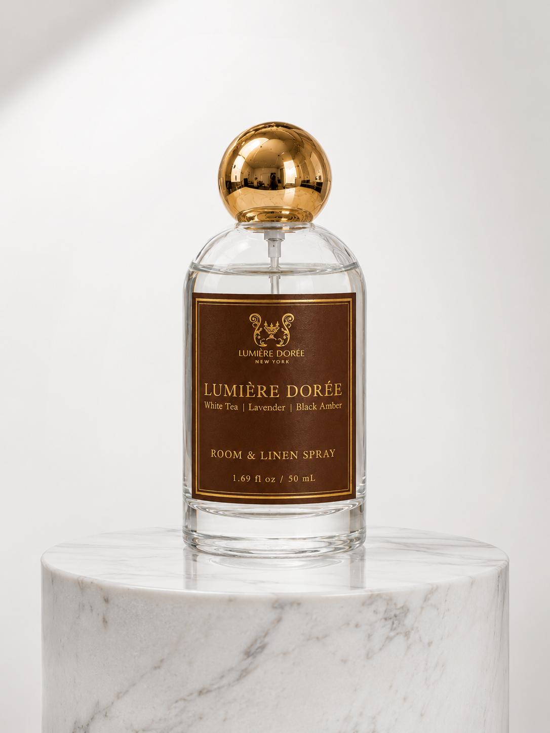 LUMIÈRE DORÉE luxury linen spray and home fragrance mist in a sleek bottle, designed to add a fine, elegant scent to rooms.