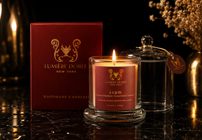 Lumière Dorée Signature Cloche Candle in a glass container with a luxurious fragrance, featuring Bargamot, Cocoa, and Cashmere scents.
