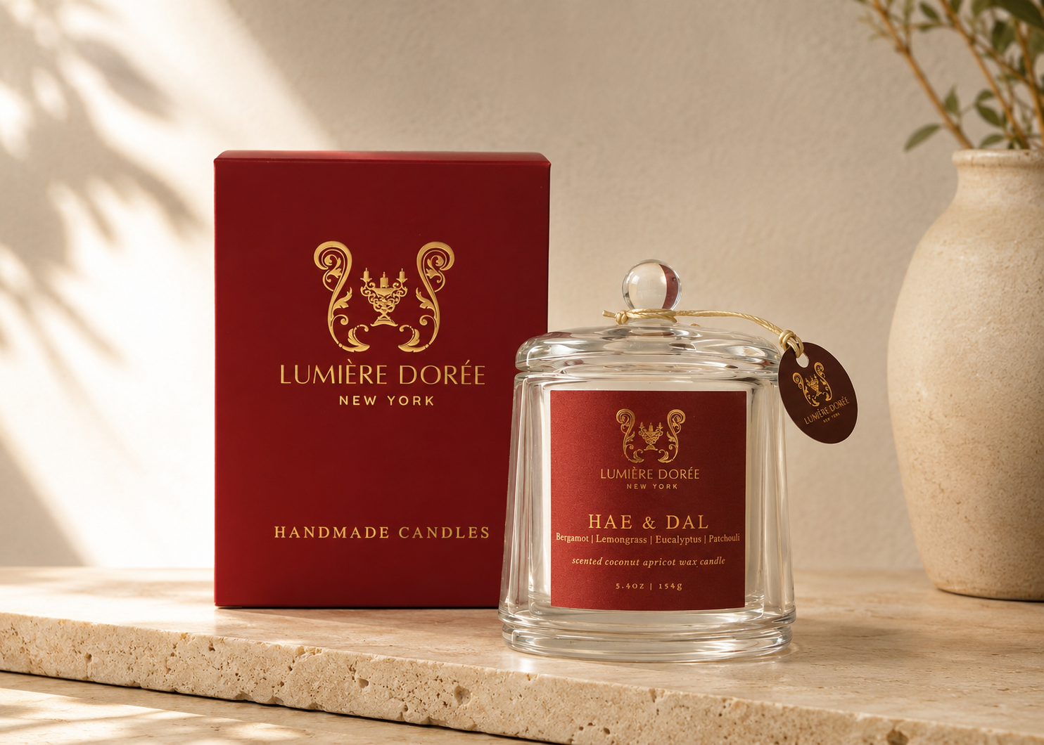 Lumière Dorée Signature Cloche Candle with lemongrass and eucalyptus scents in a glass container for elegant home fragrance.